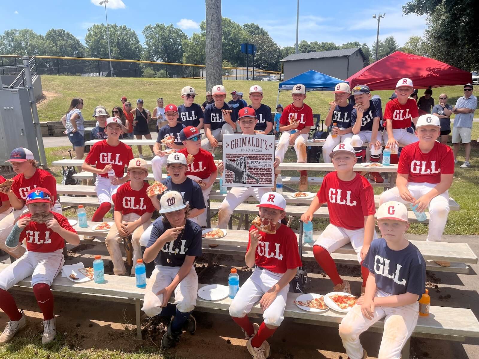 Little league team eating pizza